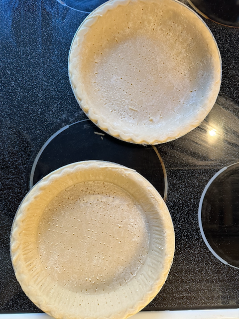 Pie shells with holes pricked in the bottom and sides